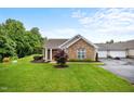 Beautiful home with stone facade, well-kept lawn, and mature landscaping for enhanced curb appeal at 306 Faith Dr, Gibsonville, NC 27249