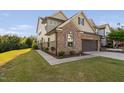 Beautiful two-story home with brick and siding, attached garage, and well-maintained lawn at 310 Alamosa Pl, Cary, NC 27519