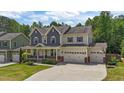 Charming two-story home with a beautifully landscaped front yard and three-car garage at 3122 Jones Lake Rd, Fuquay Varina, NC 27526