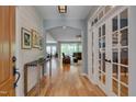 Inviting foyer with hardwood floors, shiplap walls, and stylish decor leading into the home at 316 Ibis Ln, Durham, NC 27703