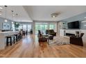 Open-concept living area with hardwood floors, fireplace, and seamless flow to dining and kitchen at 316 Ibis Ln, Durham, NC 27703