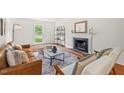 Inviting living room with fireplace, hardwood floors, and comfortable seating arrangement at 3405 Bonaparte Way, Durham, NC 27707