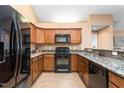 This kitchen features stainless steel appliances, granite counters, and wood cabinets at 342 Faith Dr, Gibsonville, NC 27249