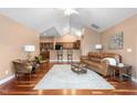 Bright living room with hardwood floors, vaulted ceiling, and open layout to the kitchen at 342 Faith Dr, Gibsonville, NC 27249