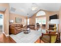 Bright living room features vaulted ceilings, fireplace, and wood floors at 342 Faith Dr, Gibsonville, NC 27249