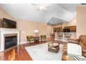 Cozy living room with fireplace, hardwood floors, and open layout to the kitchen at 342 Faith Dr, Gibsonville, NC 27249