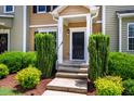 Close up on front door of home with well kept bushes and green grass at 361 Anterbury Dr # B, Apex, NC 27502