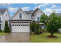Beautiful home featuring a spacious garage and well-manicured lawn at 3904 Freemark Ln, Fuquay Varina, NC 27526