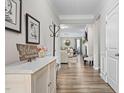 Open-concept hallway leading to the living area with modern decor, hardwood floors, and neutral paint at 3909 Mendenhall Dr, Zebulon, NC 27597