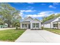 Charming one-story home featuring light gray siding and a well-manicured lawn at 401 N Raiford St, Selma, NC 27576