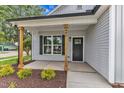 Inviting front porch featuring craftsman columns and manicured landscaping at 401 N Raiford St, Selma, NC 27576