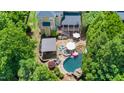 Expansive backyard with a pool, patio, and lush landscaping, perfect for outdoor entertaining at 404 Brightling Way, Holly Springs, NC 27540