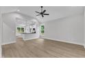 Spacious living room featuring vaulted ceilings, natural light, and seamless flow into the kitchen area at 405 N Raiford St, Selma, NC 27576