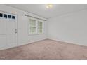 Bright bedroom featuring neutral carpet, a window, and fresh paint at 407 W Depot St, Angier, NC 27501