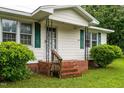 Inviting front porch with brick steps and decorative iron railings at 407 W Depot St, Angier, NC 27501