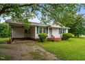Traditional home with a cozy carport and a lush green lawn at 407 W Depot St, Angier, NC 27501