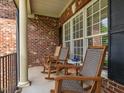 Cozy front porch featuring rocking chairs, offering a relaxing outdoor seating area at 4266 Aviemore Run, Burlington, NC 27215