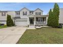 Charming two-story home featuring a covered porch, two-car garage and manicured lawn at 4621 Youngsbury Ct, Raleigh, NC 27604