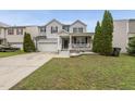 Charming two-story home featuring a covered porch, two-car garage and manicured lawn at 4621 Youngsbury Ct, Raleigh, NC 27604