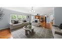 Bright living room featuring recessed lighting, modern furniture, and an open floor plan to the kitchen at 4621 Youngsbury Ct, Raleigh, NC 27604