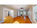 Bright living room featuring hardwood floors, ceiling fan, and seamless flow to other rooms at 504 Hillcrest Ave, Burlington, NC 27215