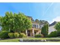 Charming two-story home featuring lush landscaping and a stone-accented front porch at 528 Bankhead Dr, Cary, NC 27519