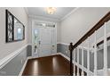 Bright and welcoming foyer with hardwood floors and a view of the front door at 5292 Goosecross Way, Fuquay Varina, NC 27526