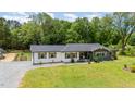 Charming single-story home with a landscaped front yard and detached garage viewed from the air at 553 Isley Rd, Haw River, NC 27258