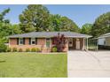Charming one story brick house with mature landscaping and well manicured lawn at 64 Red House Rd, Smithfield, NC 27577
