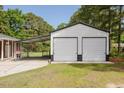 Detached garage with an attached carport and a well maintained yard at 64 Red House Rd, Smithfield, NC 27577