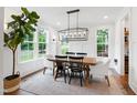 Elegant dining room with a farmhouse table, modern chandelier, and natural light at 729 Mills St, Raleigh, NC 27608