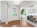 Bright foyer with hardwood floors flows into dining area, featuring modern lighting at 729 Mills St, Raleigh, NC 27608