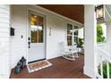 Inviting front porch with rocking chair, stylish lanterns, and a welcoming entrance at 729 Mills St, Raleigh, NC 27608
