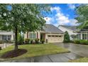 Lovely home features a well-maintained lawn, charming curb appeal, and attached two-car garage at 79 Heatherwood Dr, Chapel Hill, NC 27516