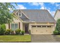 Attractive home with a well-kept lawn, a two-car garage, and delightful curb appeal at 79 Heatherwood Dr, Chapel Hill, NC 27516
