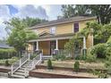 Quaint two-story home boasts a covered front porch and beautiful, mature landscaping at 813 Burch Ave, Durham, NC 27701
