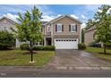 Charming two-story home with a two car garage, manicured lawn and beautiful, mature landscaping at 831 Poplar St, Durham, NC 27703