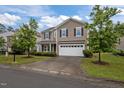 Charming two-story home with a two car garage, manicured lawn and beautiful, mature landscaping at 831 Poplar St, Durham, NC 27703