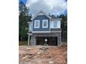 Two story home with unfinished landscaping and stone accents. Two-car garage in need of completion at 1001 Shovelhead Dr # 1, Durham, NC 27703