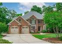 Charming brick home with a well-maintained lawn and mature trees at 102 Lions Mouth Ct, Cary, NC 27518