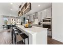 Modern kitchen with large island, stainless steel appliances, and seating for four, perfect for entertaining at 10518 Pleasant Branch Dr # 33, Raleigh, NC 27614
