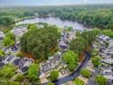 Breathtaking aerial view of a lakeside community surrounded by lush green trees and beautiful homes at 113 Spring Cove Dr, Cary, NC 27511