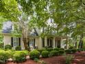Charming two-story home with meticulous landscaping, creating a welcoming and picturesque setting at 124 Creekvista Dr, Holly Springs, NC 27540
