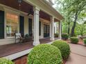 Inviting front porch with comfortable seating and meticulous landscaping enhancing curb appeal at 124 Creekvista Dr, Holly Springs, NC 27540