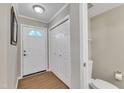 Entryway featuring a door with decorative glass, closet, and half-bath at 134 Riverwalk Cir, Cary, NC 27511