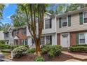 Exterior view of townhouses with varying styles, landscaping and mature trees at 134 Riverwalk Cir, Cary, NC 27511