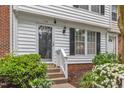 Inviting front entrance with decorative door, blooming flowers, and manicured shrubs at 134 Riverwalk Cir, Cary, NC 27511