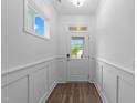 Bright foyer with white trim, wood-look flooring, and a view of the neighborhood at 143 Swain St, Clayton, NC 27527