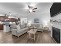 Inviting living room with comfortable seating, a ceiling fan, fireplace, and an open layout to the kitchen at 143 Swain St, Clayton, NC 27527