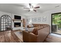 Living area showcasing a comfortable sectional sofa, fireplace, wall decor, and access to the outdoor deck at 1503 Laughridge Dr, Cary, NC 27511